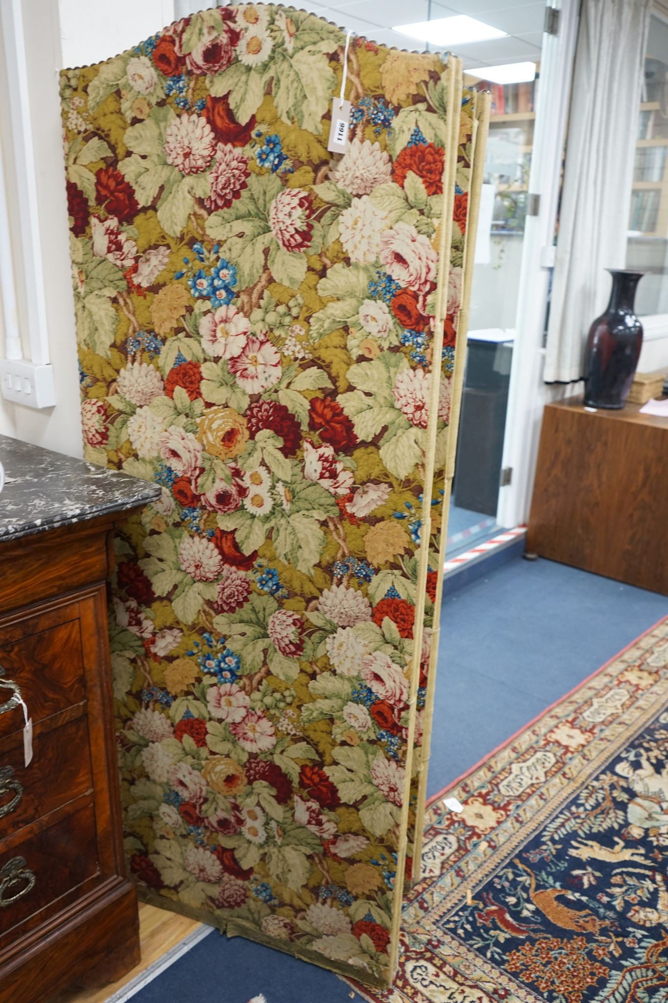 An early 20th century floral fabric four fold dressing screen, each panel width 67cm, height 176cm